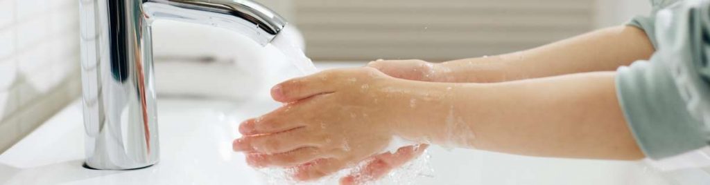 Image showing someone washing their hands, practicing good hand hygiene.